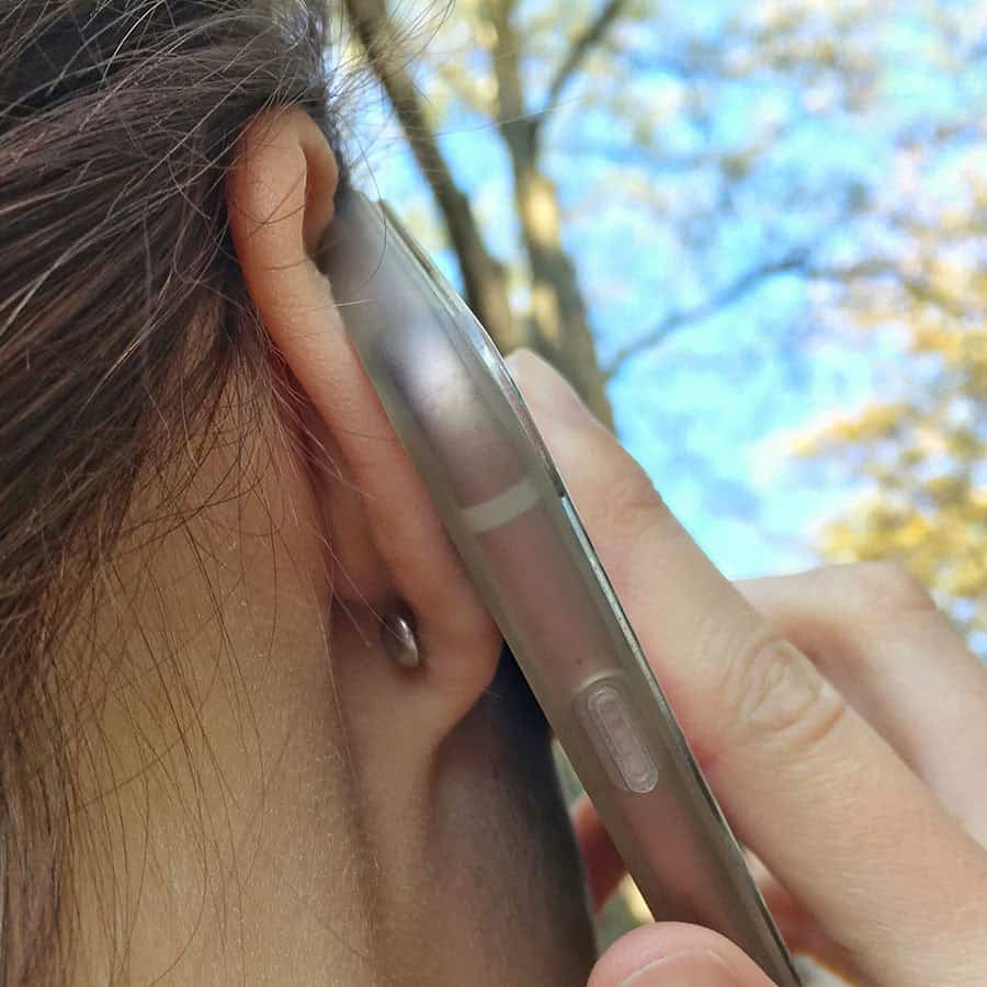 ComfyEarrings flat screw on back pictured from the back of the ear while on the phone
