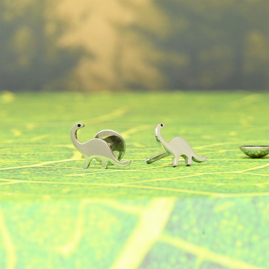 Dinosaurs ComfyEarrings on a green background
