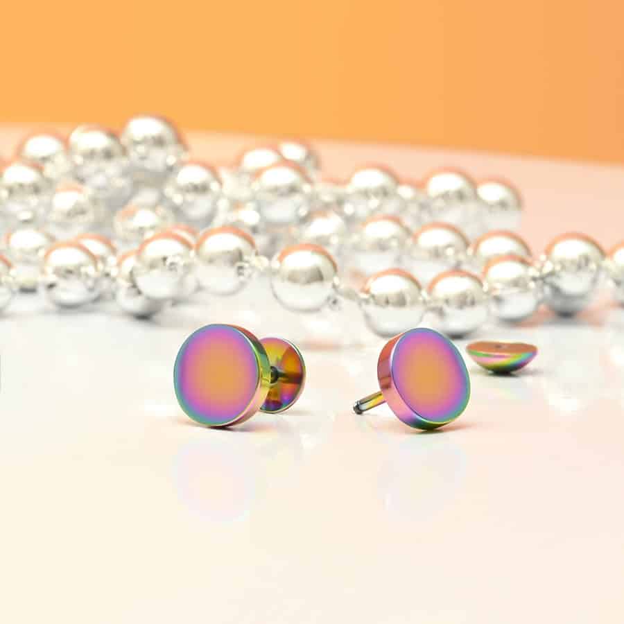 Multi Color Circle ComfyEarrings in front of silver pearls