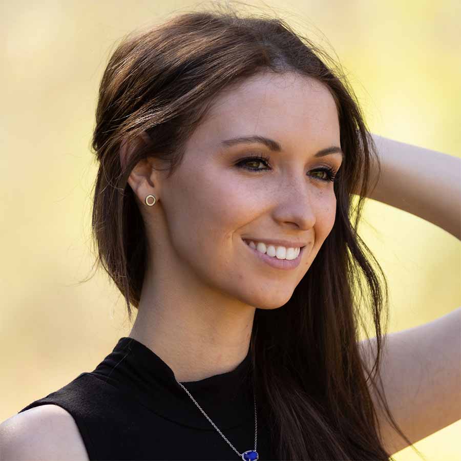 A woman wearing Open Circle Titanium ComfyEarrings out in a field.