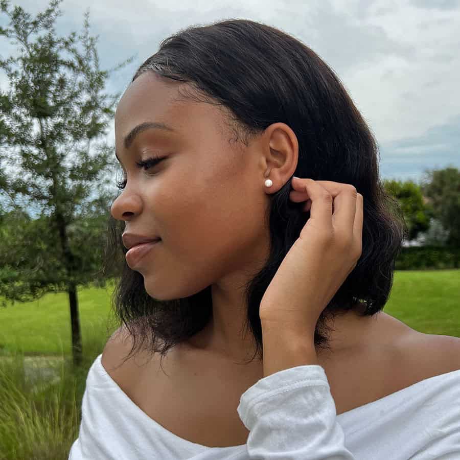 Pearl ComfyEarrings in the ear of a model side view.