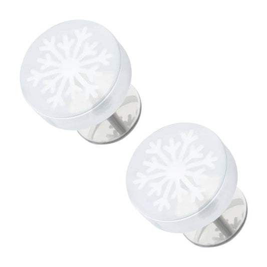 A pair of white snowflake-shaped earrings with a clear acrylic overlay, displayed against a white background.