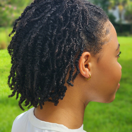 Person with small hoop earrings in an outdoor setting