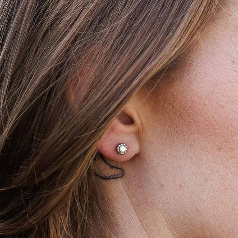 Close-up of an ear wearing Vintage Aurora Borealis ComfyEarrings stud earrings.