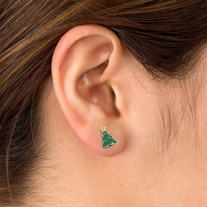 Close-up of an ear wearing a green Christmas tree earring.