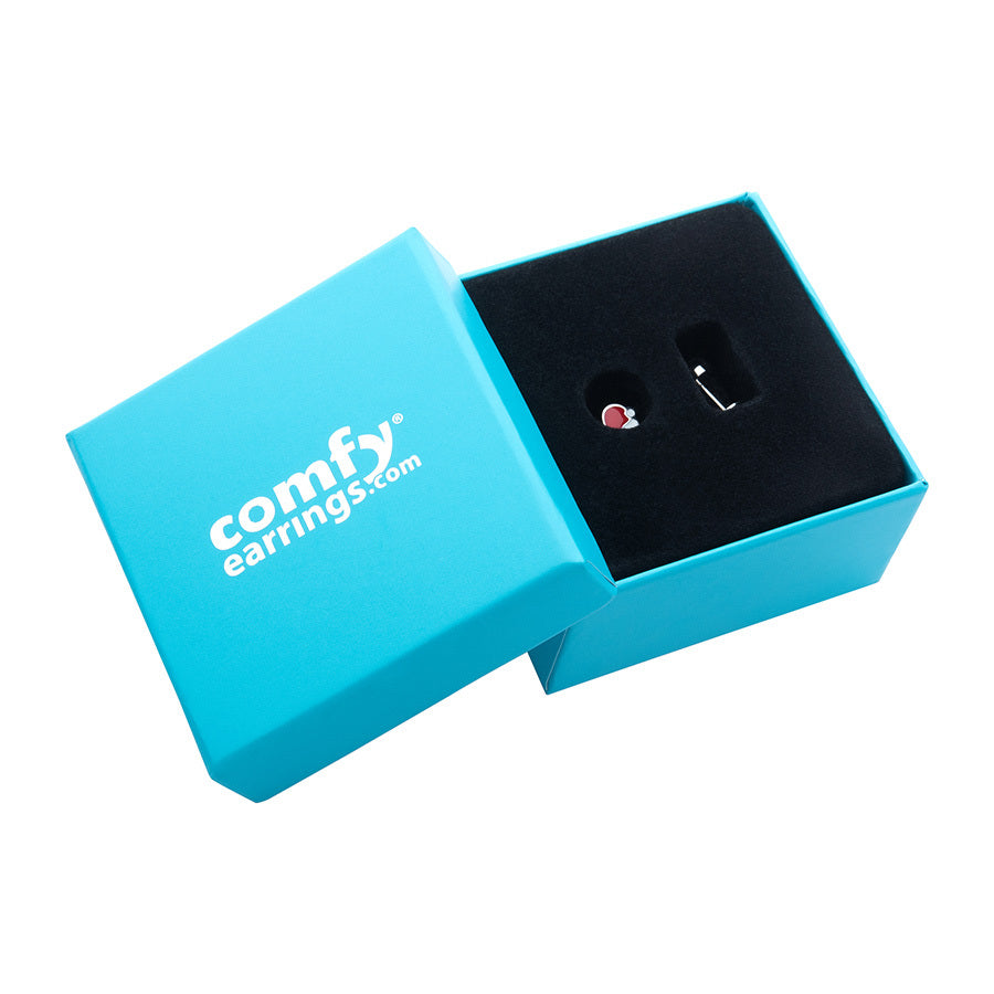 A pair of tiny santa hat earrings displayed inside a black-lined turquoise gift box. Set against a plain white background.