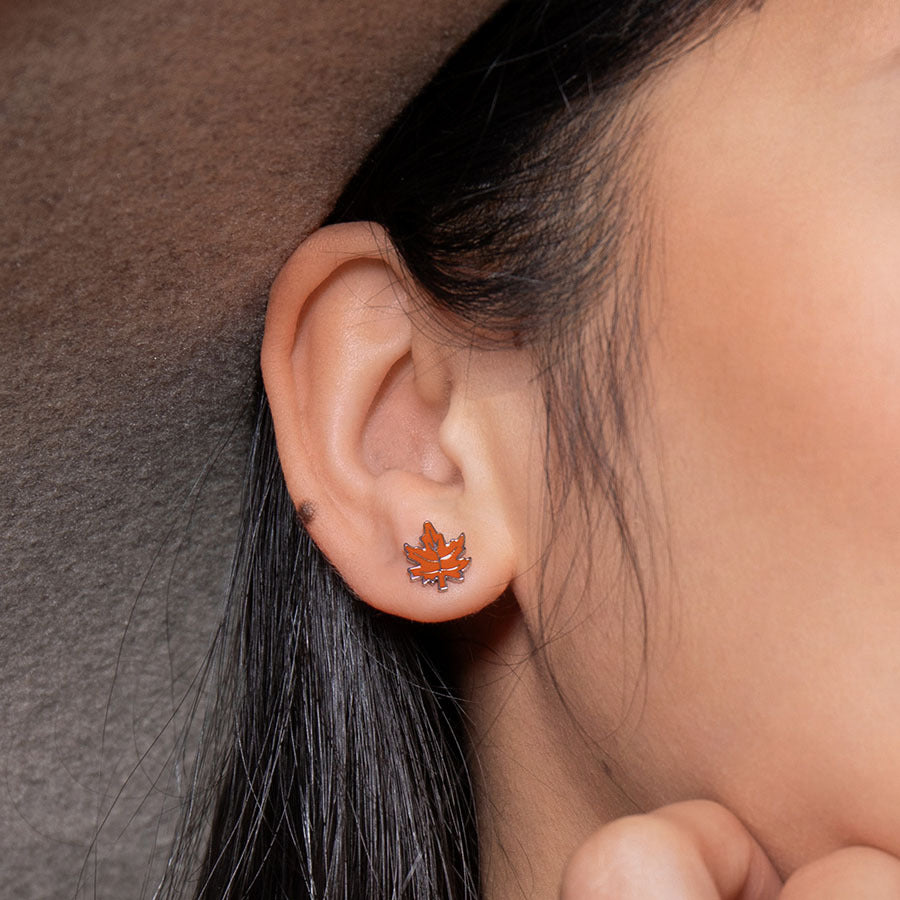 Enamel Fall Leaf ComfyEarrings up close and cozy in a model's ear. 
