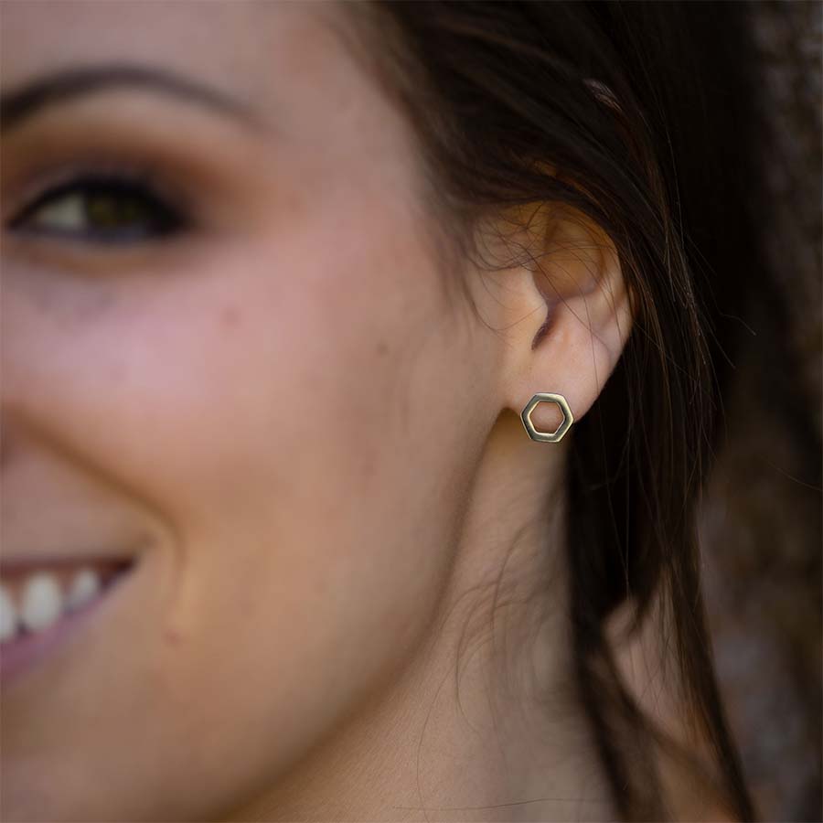 Close-up of a woman wearing Open Hexagon Titanium ComfyEarrings