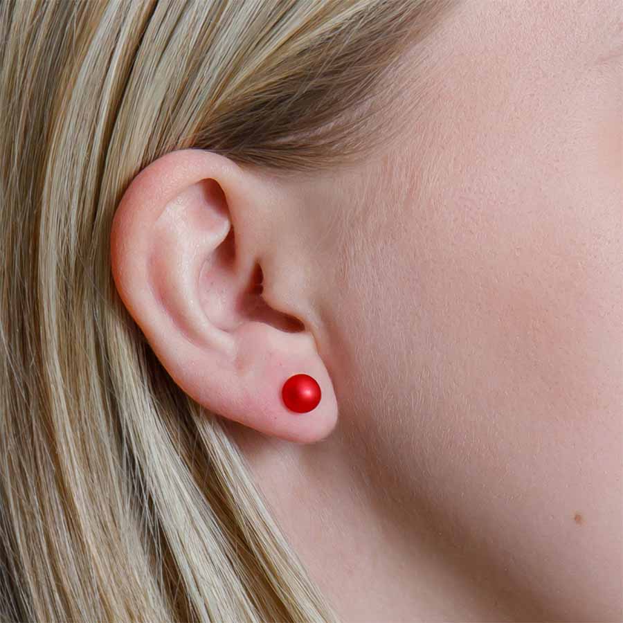 Close-up of an ear with a red earring