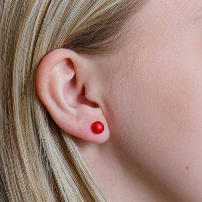 Close-up of an ear with a red earring
