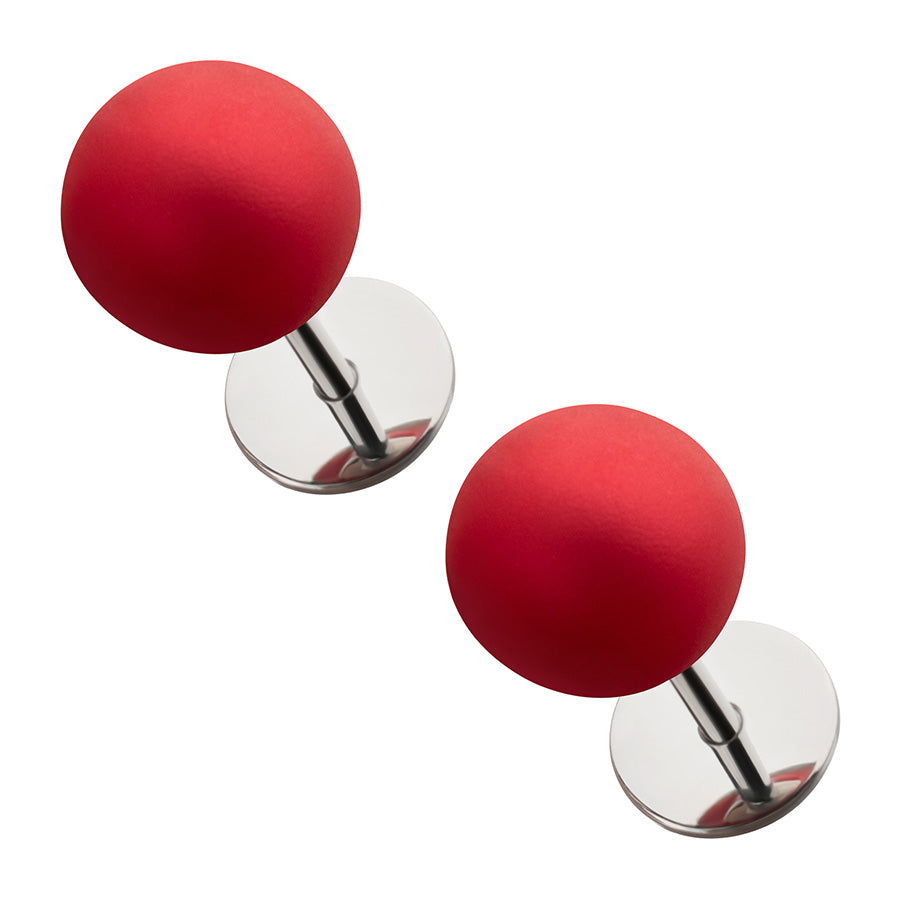 Two red spherical pearl earrings on a white background