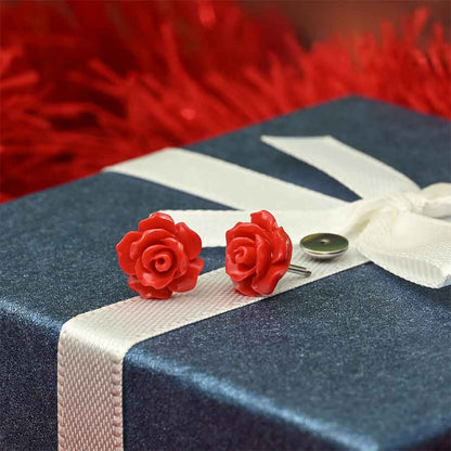 Red rose-shaped earrings on a blue box with a white ribbon. Made by ComfyEarrings