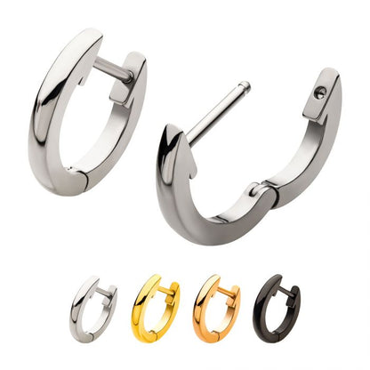 Set of hoop earrings in stainless, gold, and black on a white background