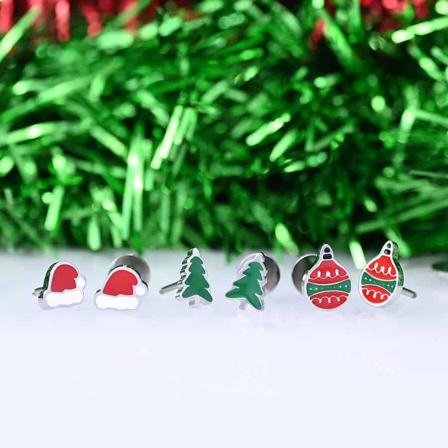 Christmas stud earrings in a row. Santa Hats, Green Trees, and Ornaments.