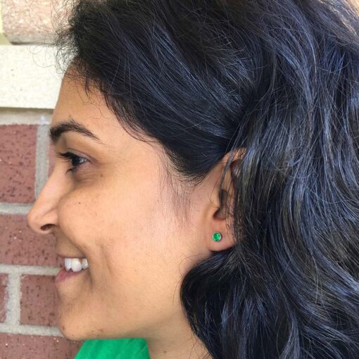 Emerald Green ComfyEarrings pictured in a fan's ear.