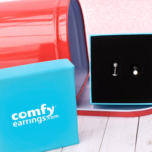 Pearl ComfyEarrings pictured in our gift box and a red mailbox.
