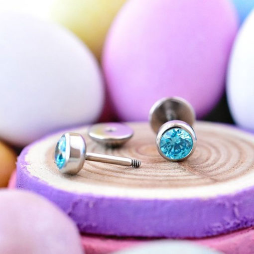 Aquamarine ComfyEarrings sitting in front of pastel easter eggs.