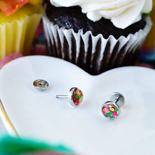 Funfetti ComfyEarrings on heart shape dish in front of cupcakes.
