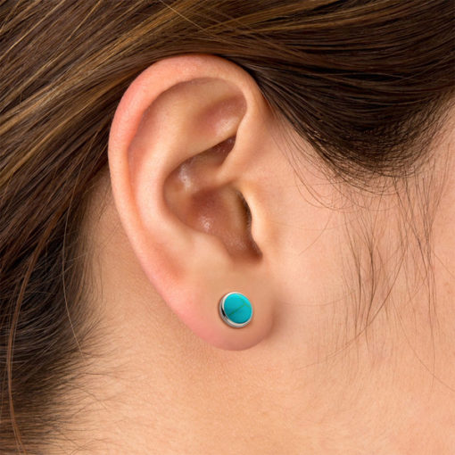 Turquoise ComfyEarrings pictured in the ear.