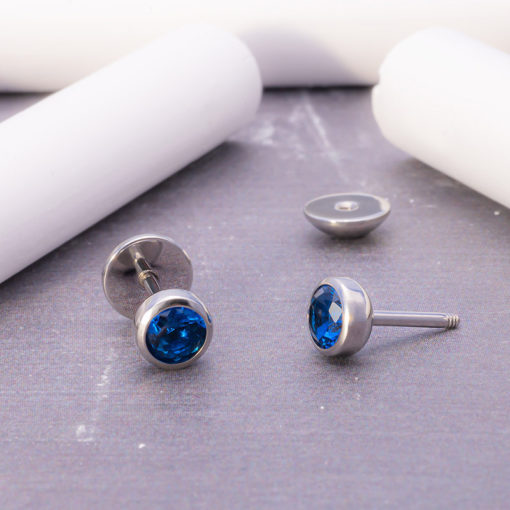 Sapphire ComfyEarrings sitting on chalkboard with white chalk stick
