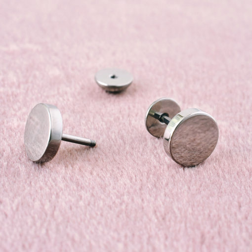 Stainless Circle ComfyEarrings on fuzzy pink surface.