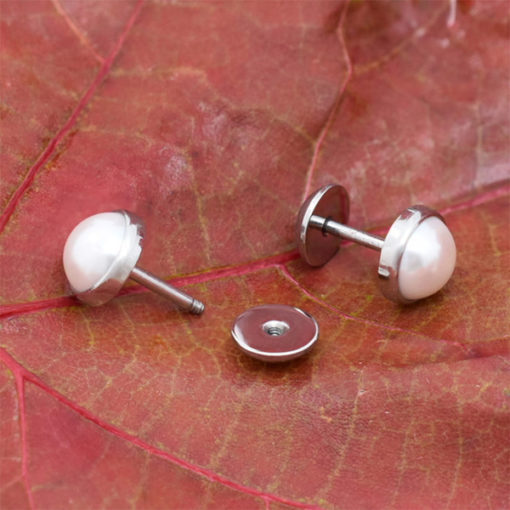 Half Round Pearl ComfyEarrings on red fall leaf.