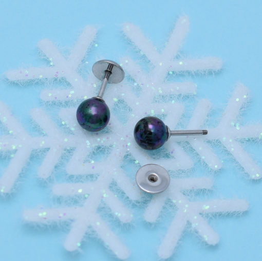 Peacock Pearl ComfyEarrings on snowflake decoration.