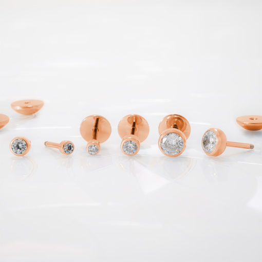 Crystal Clear Rose Gold ComfyEarrings on a reflective white background.