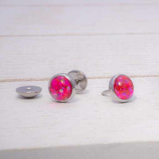 Pink Funfetti ComfyEarrings on white wood background.