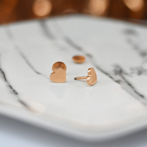 Rose Gold Heart ComfyEarrings on marble dish and rose gold streamer background