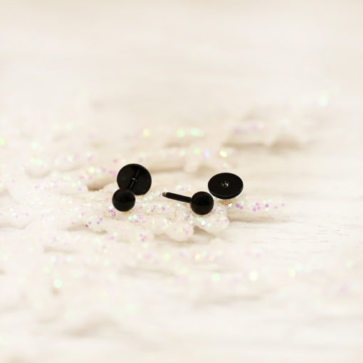 Modern Black Ball ComfyEarrings on white glitter snowflake ornaments