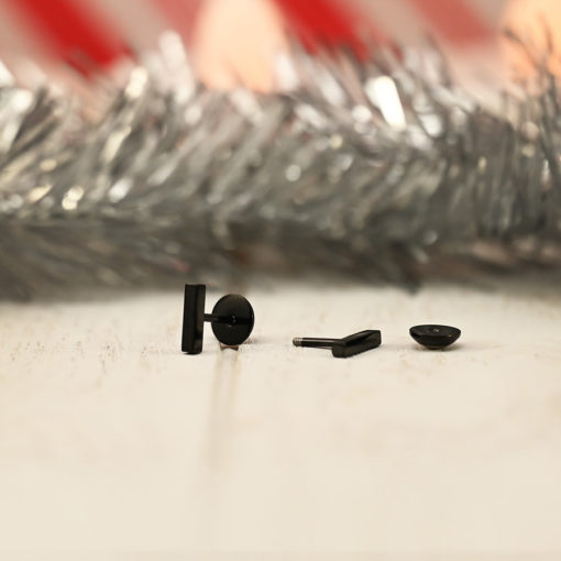 Modern Black Bar ComfyEarrings in front of silver tinsel.