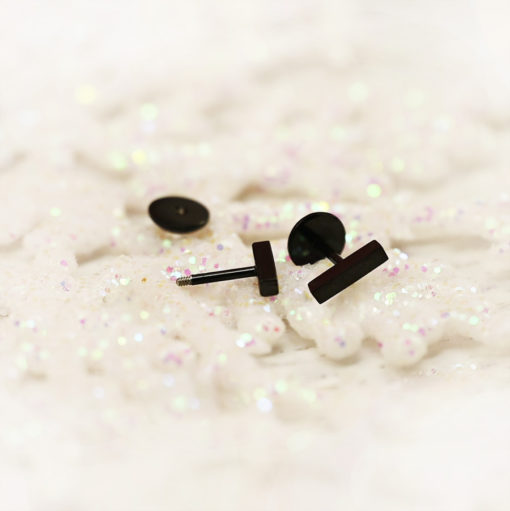 Modern Black Bar ComfyEarrings on a white glitter snowflake ornaments