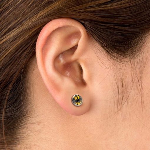 Black and Gold ComfyEarrings in a model's ear.