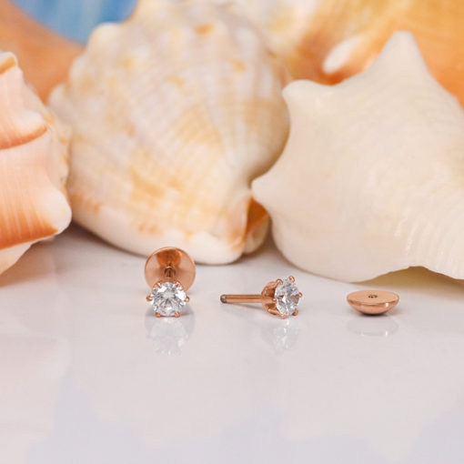 Rose Gold Prong ComfyEarrings 4.0 mm in front of seashells