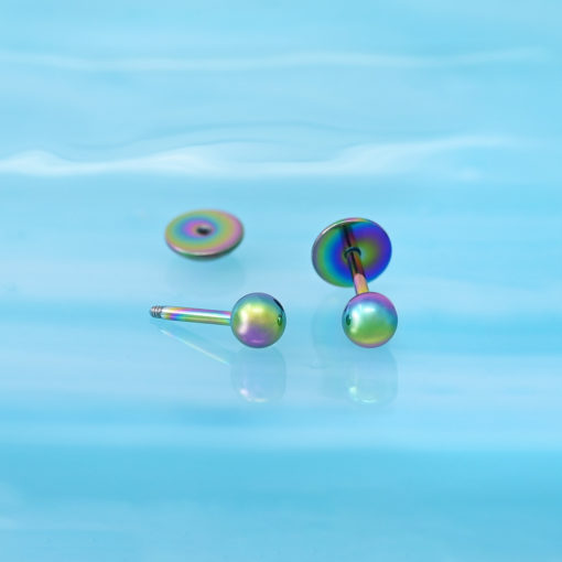 Multicolor Ball ComfyEarrings on a reflective blue background