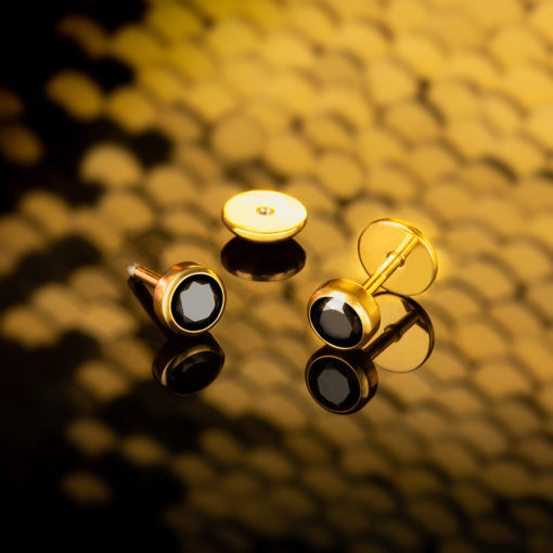 Black Onyx Gold ComfyEarrings on a black and gold sequin background.