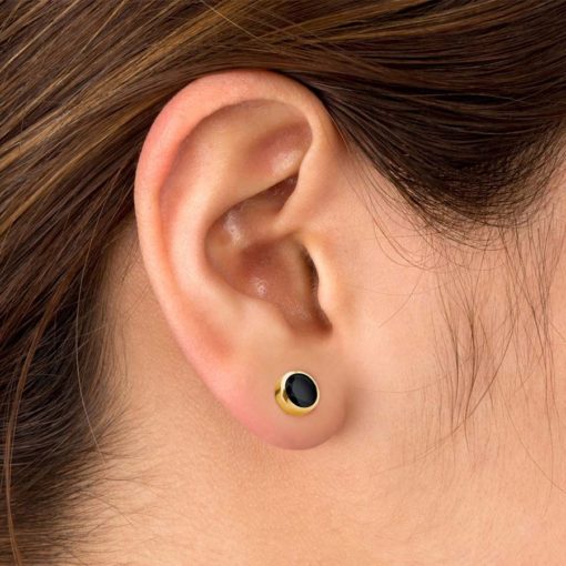 Black Onyx ComfyEarrings Gold pictured in a woman's ear.