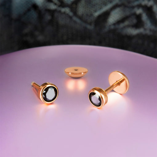 Black Onyx Rose Gold ComfyEarrings on a purple and black background.