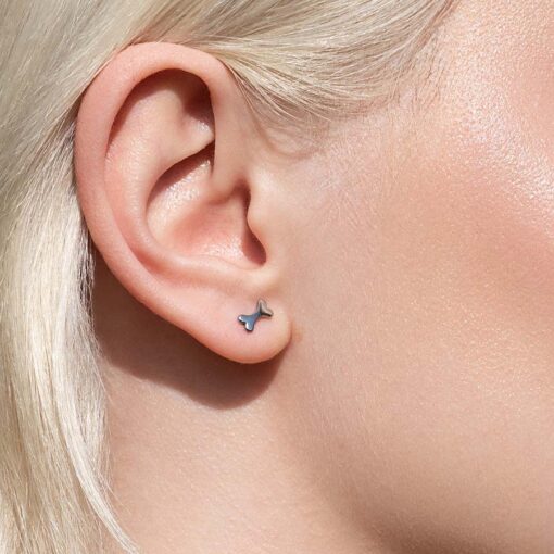 Bone ComfyEarrings pictured in a woman's ear from the side.