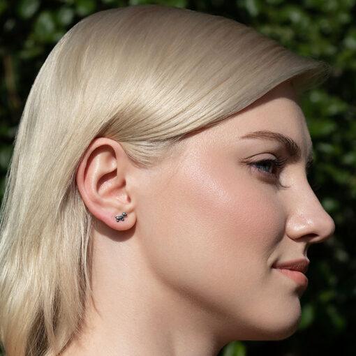 Dog ComfyEarrings pictured in a models ear.