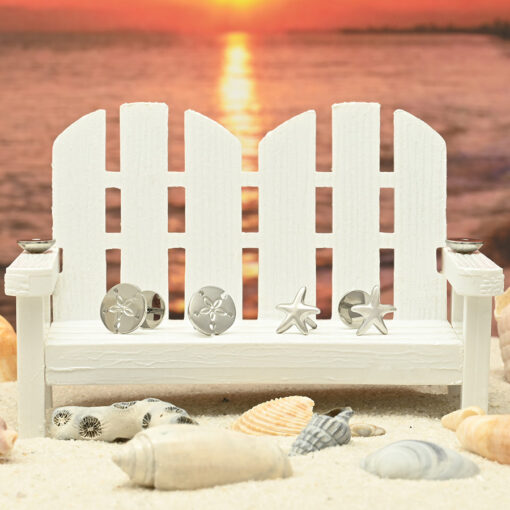 Stainless Sand Dollar and Starfish ComfyEarrings sitting on a mini white bench with seashells and a red sunset.