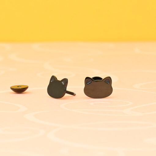 Modern (Black) Cat ComfyEarrings pictured on a yellow background.