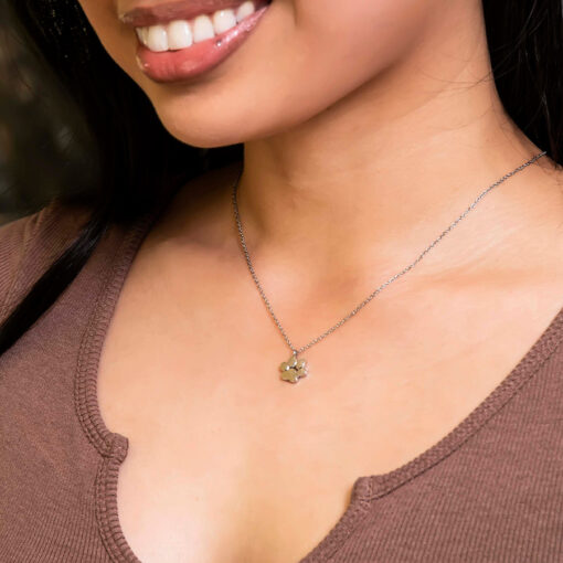 Stainless Paw Print Necklace by ComfyEarrings pictured on a model's neck.