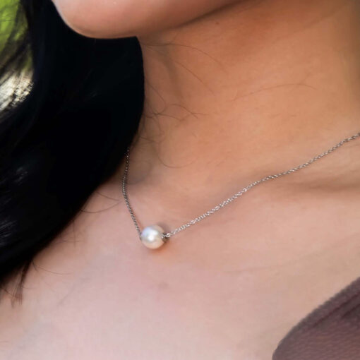 Pearl Necklace by ComfyEarrings being worn by a model close up view.