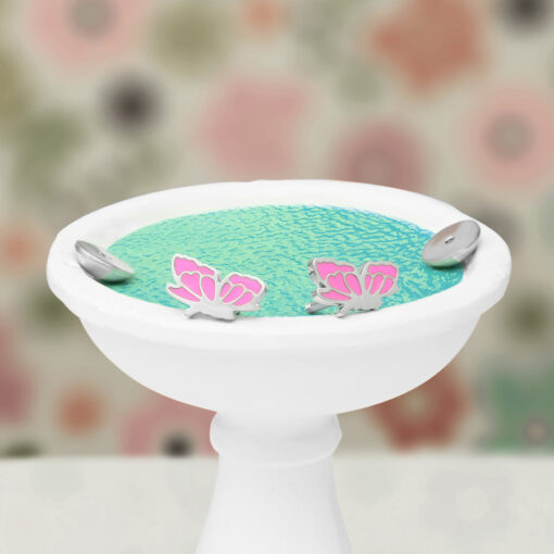 Enamel Butterfly ComfyEarrings on a mini bird bath with rippling water.