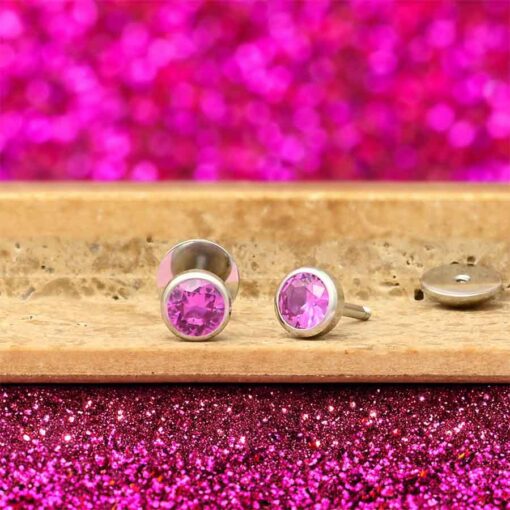 Hot Pink ComfyEarrings on a tile in front of pink glitter.