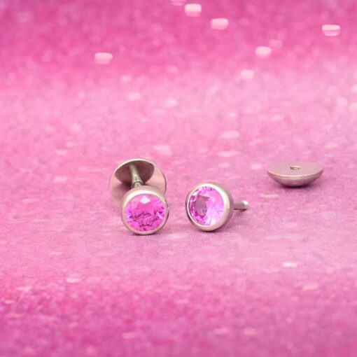 Hot Pink ComfyEarrings on a sparkly hot pink background.