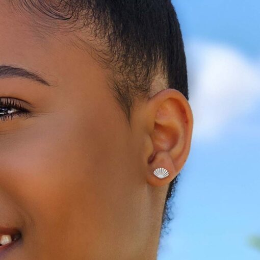 Seashell ComfyEarrings up close in a model's ear.