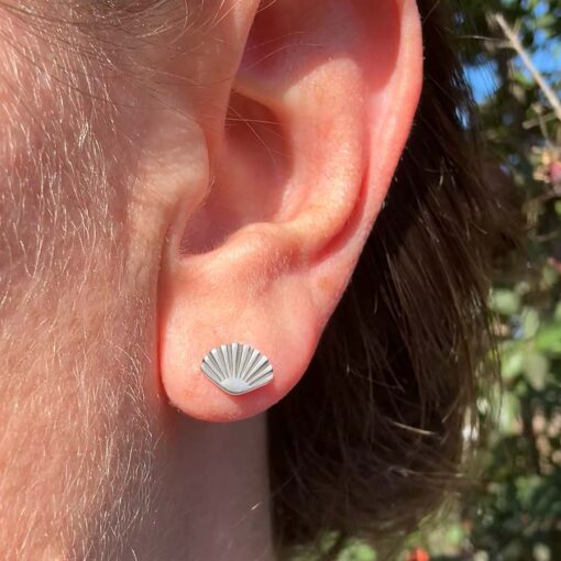 Seashell ComfyEarrings in a woman's ear.